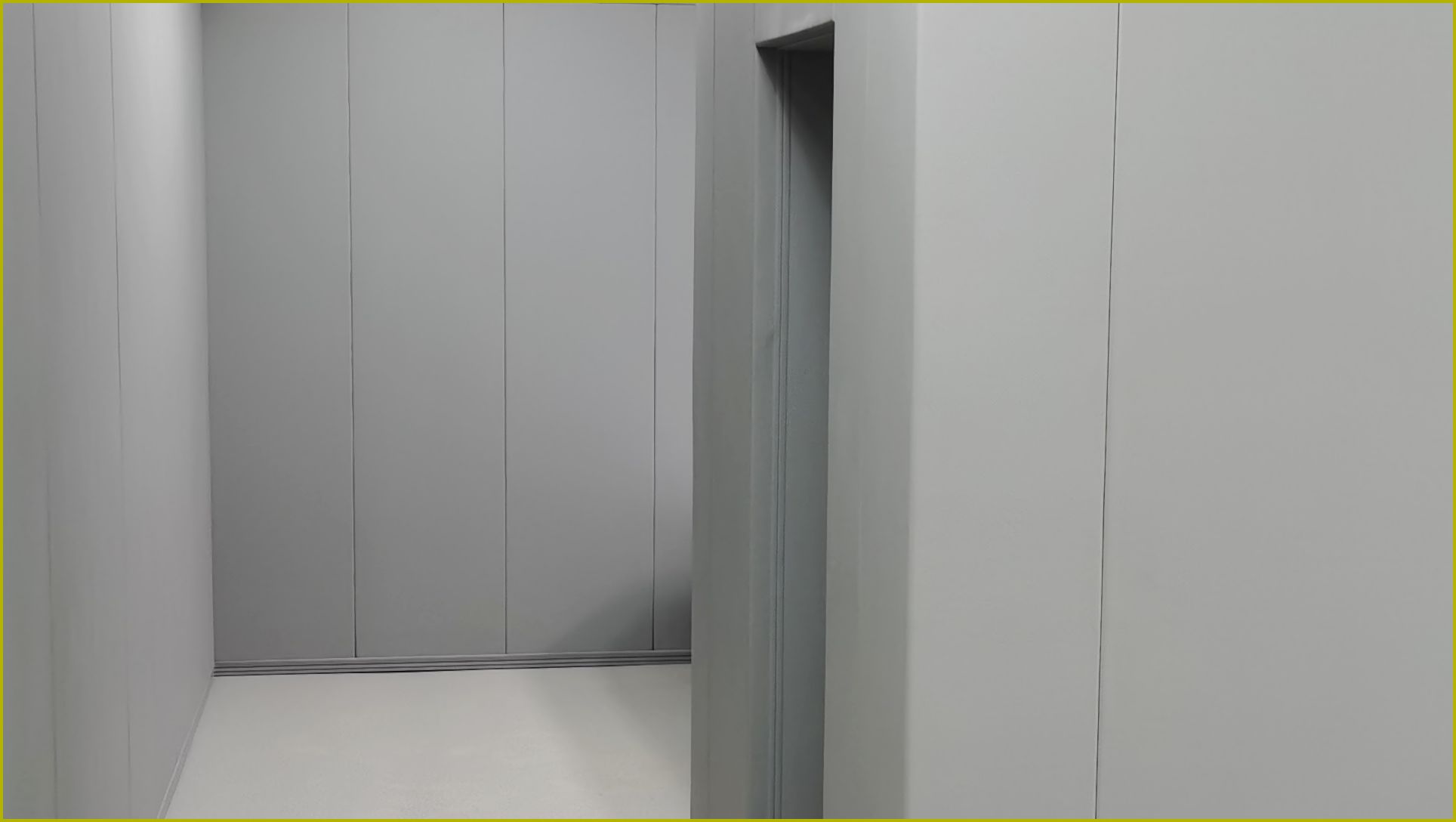 办案区审讯室灰色防撞软包墙板整体安装实景,高密度海绵软包墙面满铺配防撞地脚线,防自伤防撞处理
